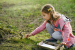 Scavenger hunt for kid in the park. Girl learning about environment. Natural education activity for World Earth day. Exploring in spring.