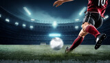 Fototapeta Sport - football soccer player kicking in action in red team night stadium background, champions league, euro cup, nations cup ,world cup ,Portugal ,England or Egypt with copy space africa nations cup	