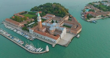 Wall Mural - Aerial orbit over island of San Giorgio di Maggiore church Venice city skyline, Italy. Panorama drone footage of famous tourist travel attraction cityscape from above. Grand Canal and lagoon.