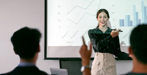 businesswoman presenting annual reports of the successful business company in meeting room.