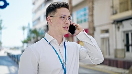 Poster - Young hispanic man smiling confident talking on smartphone at street