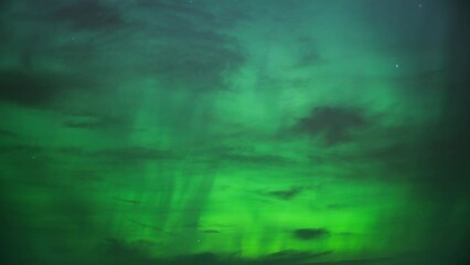Wall Mural - The night sky lit with bright green color of Northern Lights (Aurora Borealis). Timelapse. 