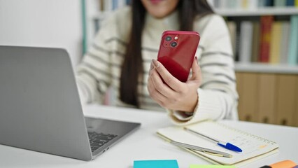 Poster - Young beautiful hispanic woman student using laptop and smartphone at library university