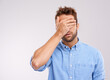 Mockup, covering eyes and man with regret, mistake and guy against a grey studio background. Male person, model or human with hand on face, frustrated and problem with an issue, upset or disappointed