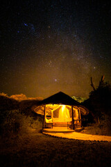 Night scene with stars, exterior of a luxury lodge, Amboseli National Park, Kenya.