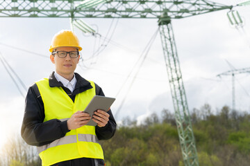 Poster - Engineer with digital tablet on a background of power line tower	