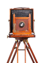 Antique Bellows Style Camera Front View Close Up On An Old Tripod Isolated On White