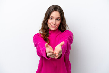 Wall Mural - Young caucasian woman isolated on white background holding copyspace imaginary on the palm to insert an ad