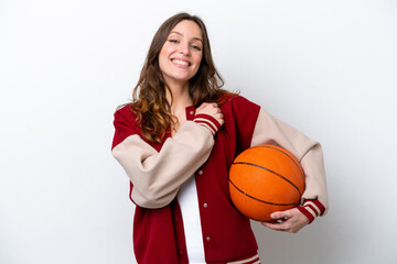 Wall Mural - Young caucasian woman playing basketball isolated on white background celebrating a victory