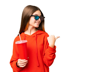 Sticker - Teenager girl in a cinema over isolated chroma key background pointing to the side to present a product