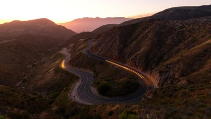 Wall Mural - night time lapse of traffic on a road winding through the mountains near los angeles.