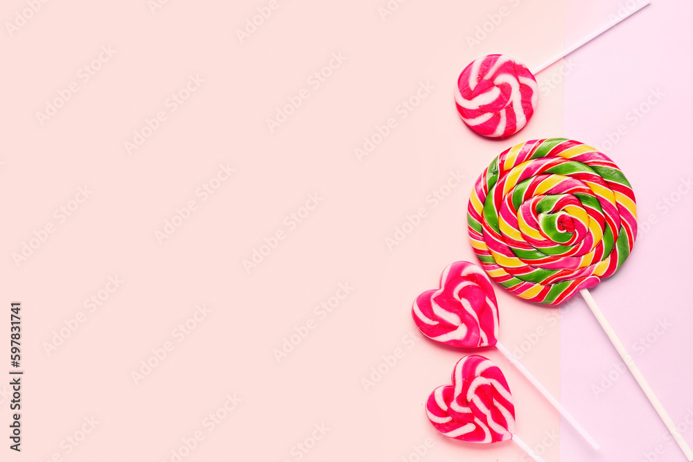 Sweet lollipops on pink and lilac background