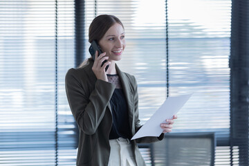 Happy young businesswoman  American siting on the chair cheerful demeanor raise holding coffee cup smiling looking laptop screen.Making opportunities female working successful in the office.