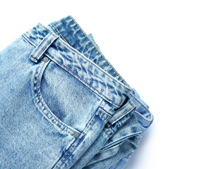 Sticker - Folded jeans on white background, closeup