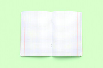 Blank copybook pages on green background