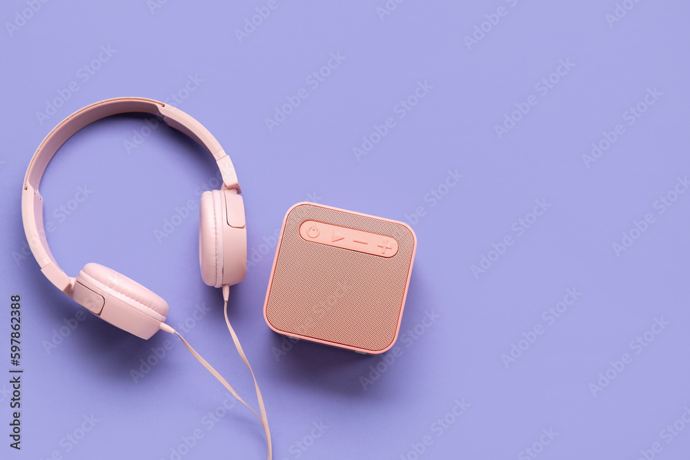 Speaker and headphones on color background