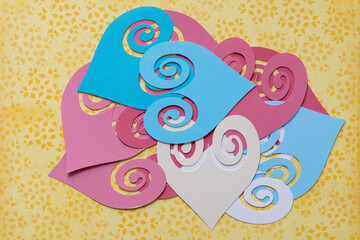 Canvas Print - pile of ornamental heart shape cutouts on yellow scrapbook paper