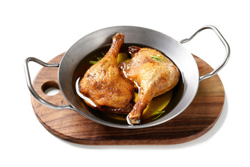 Wall Mural - Freshly roasted duck legs confit in pan, isolated on white background.