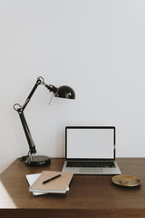 Wall Mural - Minimalist home office desk workspace with laptop computer, lamp on table. Front view copy space blank mock up template