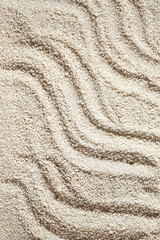 Waves ornament on neutral beige beach sand texture, aesthetic minimalist summer vacation background, copy space