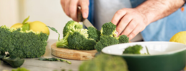 Canvas Print - Man hands prepares food on cutting board. Healthy food concept