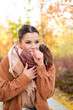 © Ladanifer - Caucasian young woman coughing during autumn.