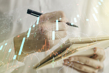 Poster - Multi exposure of abstract creative financial chart with world map and with man hand writing in notebook on background, research and analytics concept