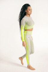 Wall Mural - Athletic confident strong woman walking full-length in fitness clothes tight comfortable, active lifestyle.