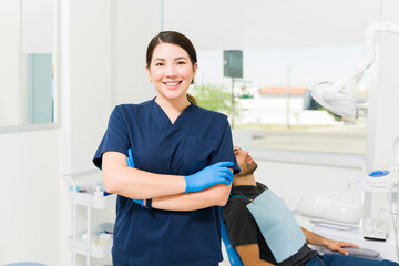 Wall Mural - Happy beautiful female dentist ready to treat a patient