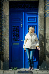 Sticker - A woman stands near the front door of an building in Porto, Portugal.