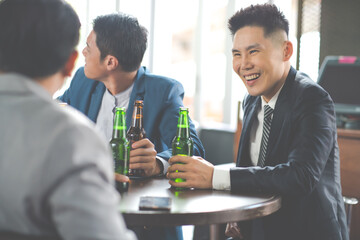 Wall Mural - Group Of Asian Friends Enjoying Evening Drinks in bar. Celebration, Party People Christmas and Happy new year concept. Asian business people in party.