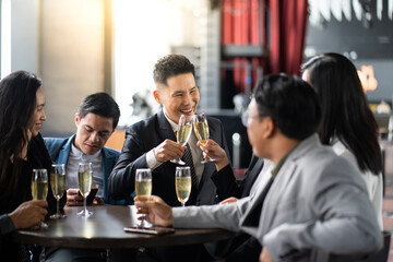 Wall Mural - Group Of Asian Friends Enjoying Evening Drinks in bar. Celebration, Party People Christmas and Happy new year concept. Asian business people in party.