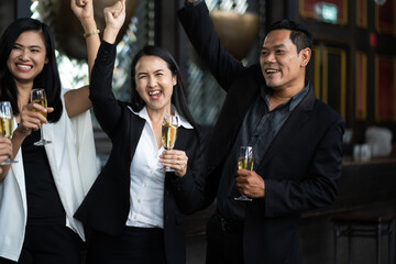 Wall Mural - Group Of Asian Friends Enjoying Evening Drinks in bar. Celebration, Party People Christmas and Happy new year concept. Asian business people in party.