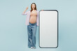 © ViDi Studio - Full body young pregnant mom woman with belly tummy with baby wearing casual clothes big huge blank screen area mobile cell phone point finger up isolated on plain blue background. Maternity concept.