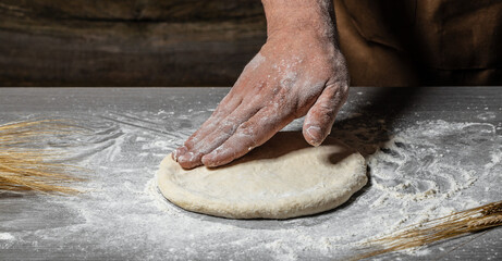 Wall Mural - Pizza dough, men hands Cooking bread. Hands kneading raw dough. Culinary, cooking, bakery concept