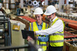 © kongga studio - The project manager and engineers are inspecting workpieces and checking standards and safety for products and safety in the factory. Technician and Female Worker Talking on a Meeting in a Factory.