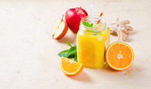 Fresh Smoothie With Orange, Apple And Ginger In A Glass Jar, Vitamin Drink, Detox, Cocktail On Bright Background