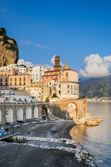 Wall Mural - Atrani, Italy. View of the small seaside village of Atrani and its beach, on the Amalfi Coast. In the distance the coast of Salerno. Vertical image. 2022-12-28.
