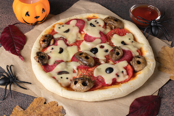 Themed food for Halloween - pizza with cheese ghosts and mushrooms form of skulls