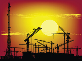 Canvas Print - sunset sun above hoisting cranes and buildings