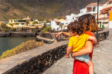 Wall Mural - A mother with son in the village of Tamaduste located on the coast of the island of El Hierro in the Canary Islands, Spain