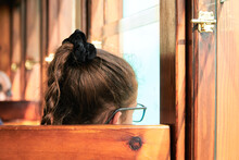 Girl With Glasses Traveling Inside A Vintage Wooden Train