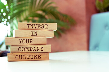 Wooden blocks with words 'Invest in your company culture'.