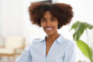 Wall Mural - Portrait of smiling African American woman indoors