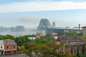 Poster - Strip of white cloud crosses sky over Sydney Harbour bridge and mist hangs over harbour and city in view from Observatory Hill