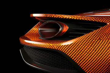 Wall Mural - The carbon fiber body of an orange and black GT race car with its sharp curves and intricate details illuminated Speed drive concept. AI generation. Generative AI