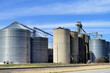 Grain elevators at a farmers cooperative complex beside a railroad mainline in a small north central Illinois community. 