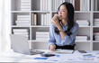 © David - Asian Business woman using calculator and laptop for doing math finance on an office desk, tax, report, accounting, statistics, and analytical research concept