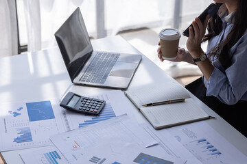 Wall Mural - Asian Business woman using calculator and laptop for doing math finance on an office desk, tax, report, accounting, statistics, and analytical research concept
