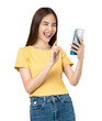 © sitthiphong - Beautiful Asian woman holding smartphone and smiling on png background.